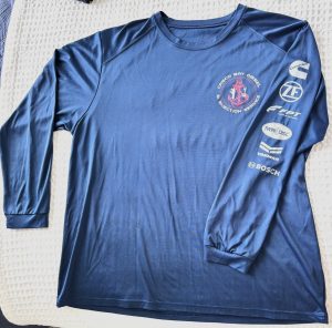 Ocean blue Casco Bay Diesel long-sleeve fishing tee laid flat, featuring chest logo and sleeve logos of Cummins, ZF, FPT, Twin Disc, Yanmar, and Bosch.